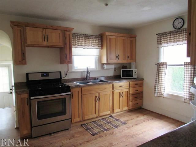 6972 Red Road Clinton, IL 61727 - Photo 9 of 17 a kitchen with a stove a sink and a window