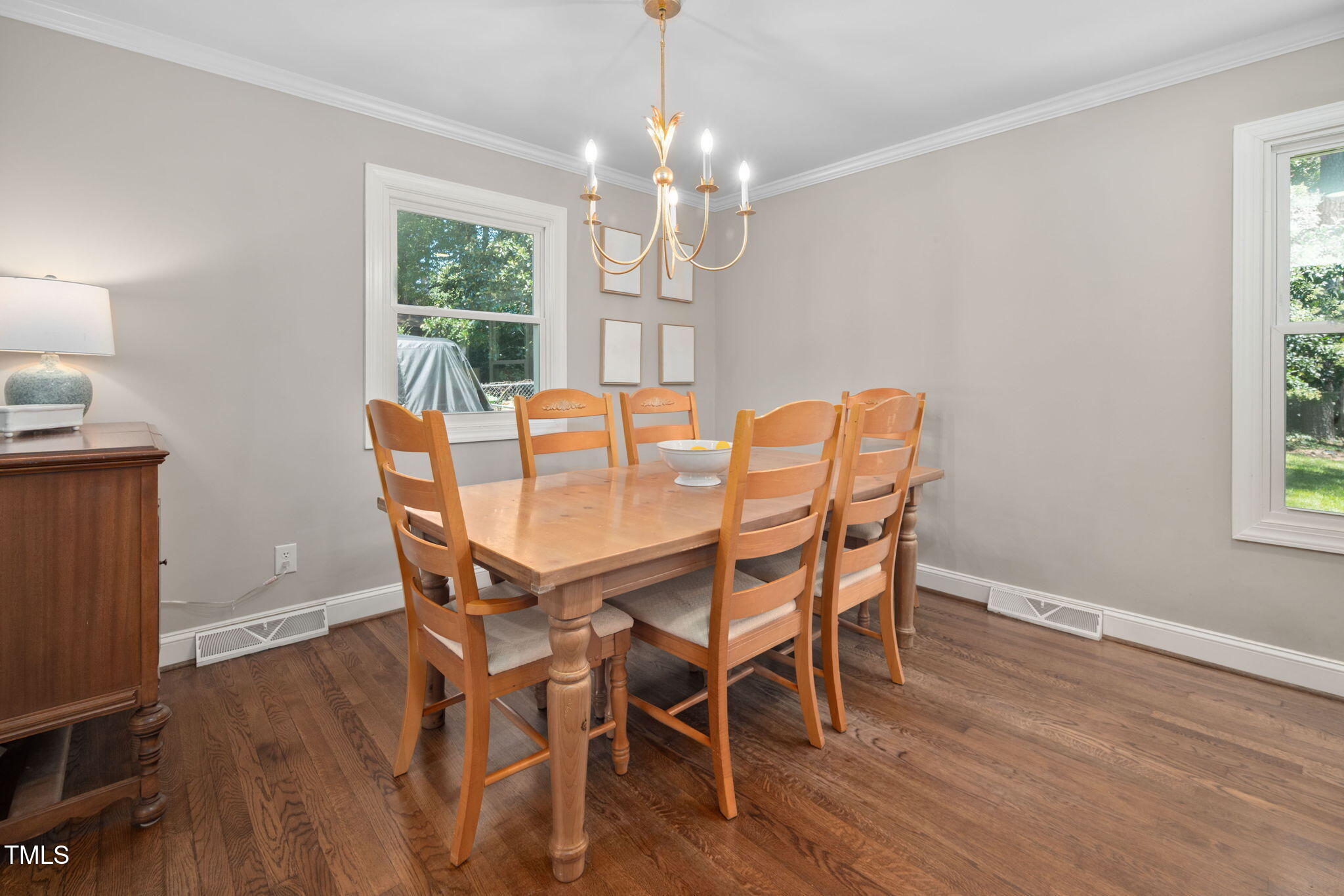 4808 Latimer Road Raleigh, NC 27609 - Photo 12 of 39 a dining room with furniture a chandelier and wooden floor