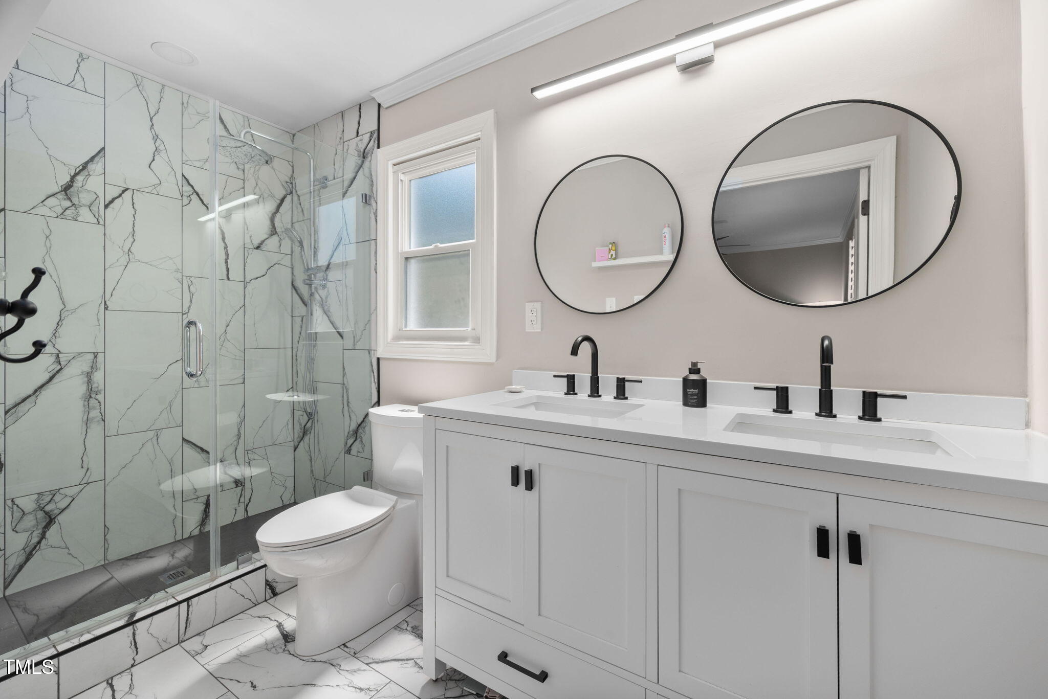 4808 Latimer Road Raleigh, NC 27609 - Photo 22 of 39 a bathroom with a toilet a sink a mirror and shower