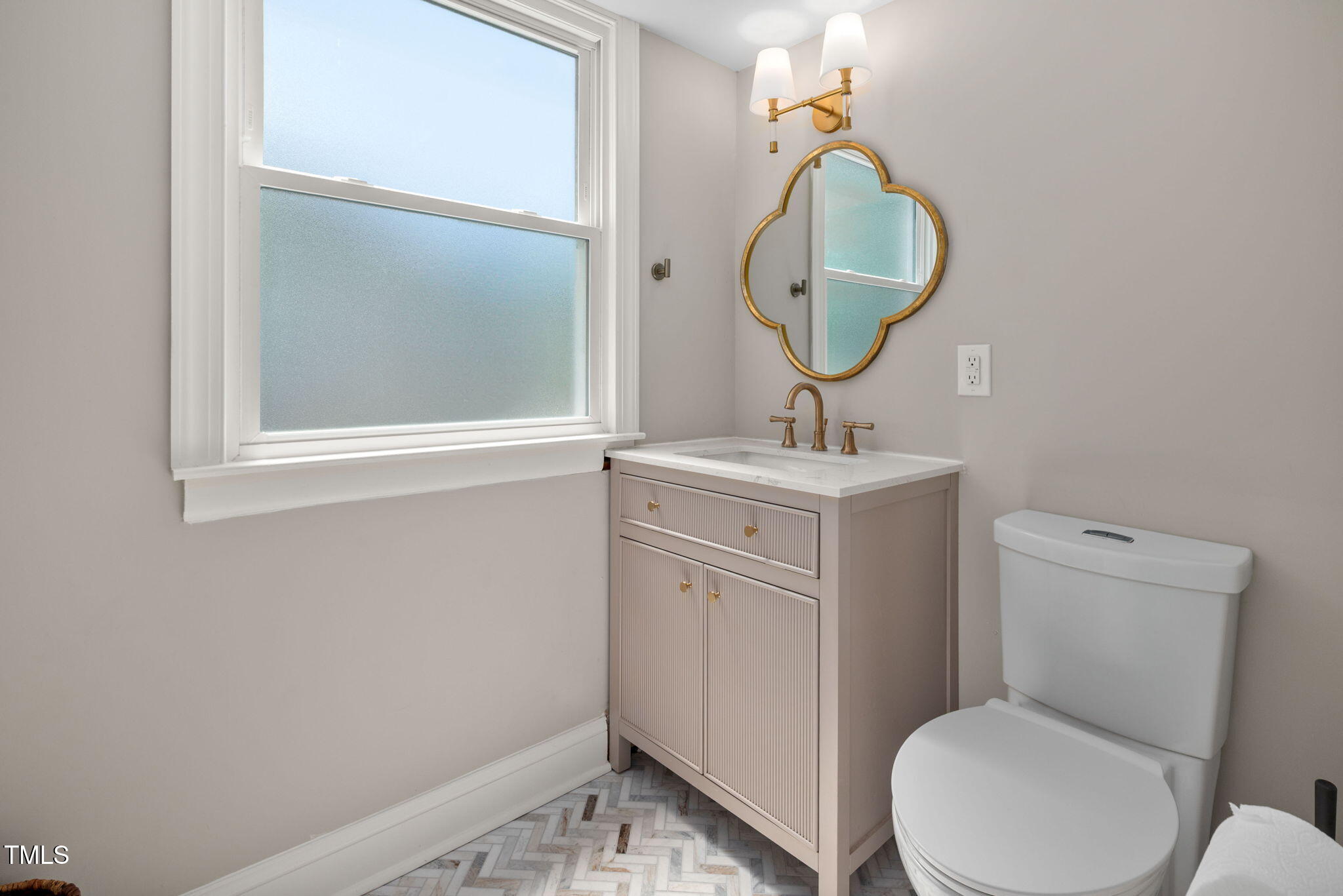 4808 Latimer Road Raleigh, NC 27609 - Photo 28 of 39 a bathroom with a toilet sink and mirror