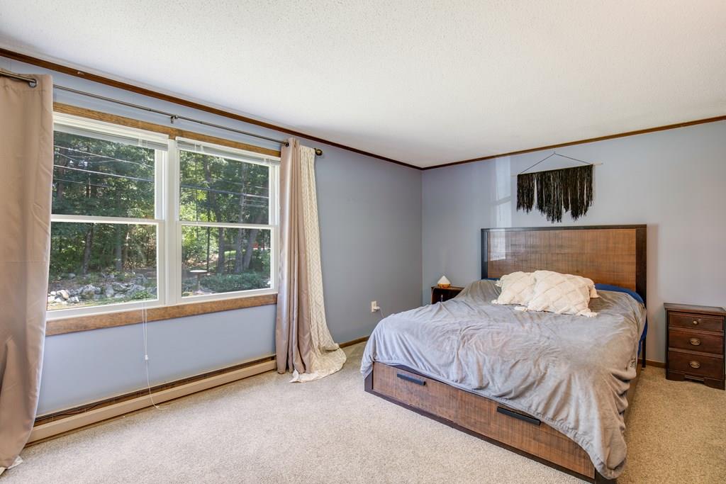 81 Newbury Road Rowley, MA 01969 - Photo 19 of 25 a bedroom with a bed and a television