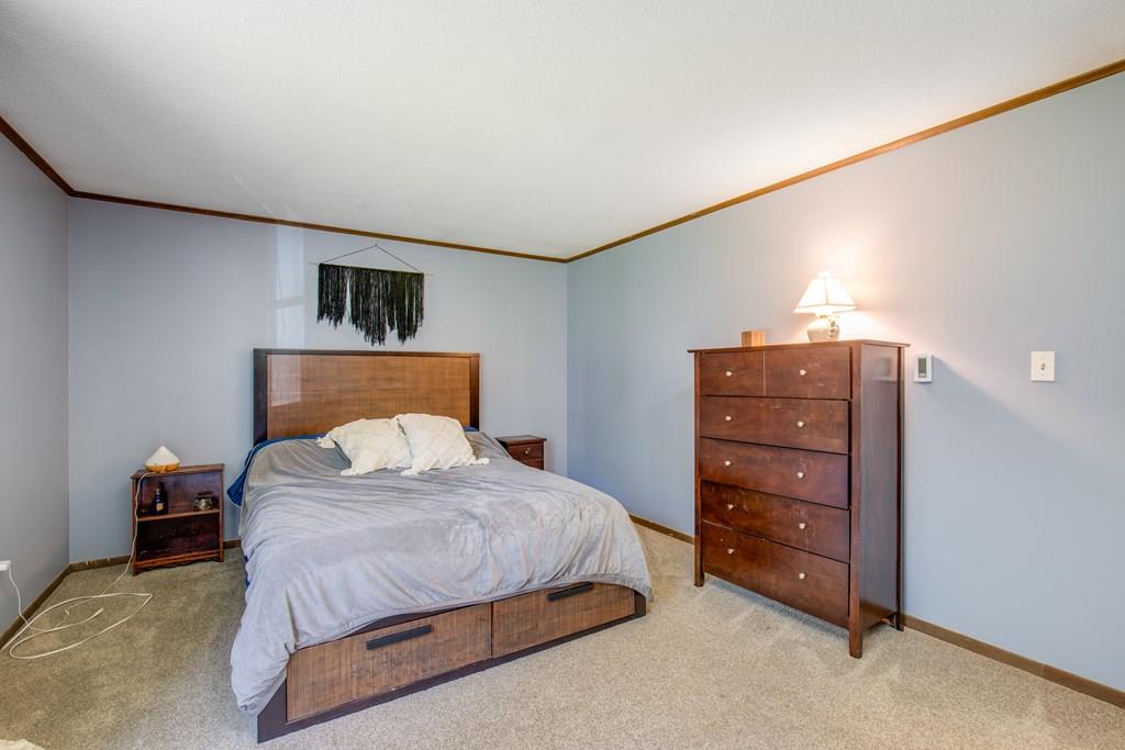 81 Newbury Road Rowley, MA 01969 - Photo 20 of 25 a bedroom with a bed and a television