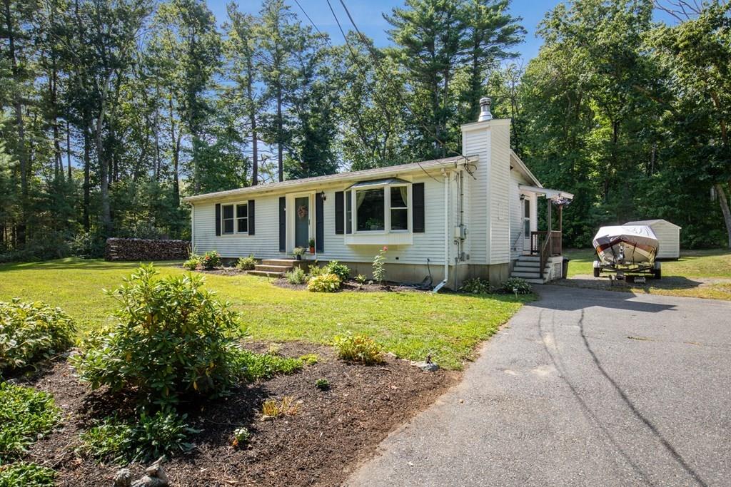 81 Newbury Road Rowley, MA 01969 - Photo 2 of 25 a front view of house with yard and outdoor seating
