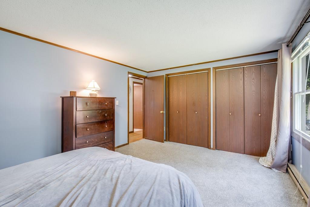81 Newbury Road Rowley, MA 01969 - Photo 21 of 25 a bedroom with a bed and wooden floor