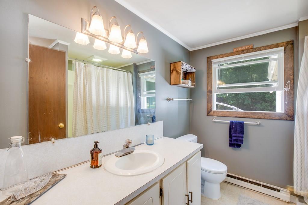 81 Newbury Road Rowley, MA 01969 - Photo 23 of 25 a bathroom with a sink a toilet and a mirror