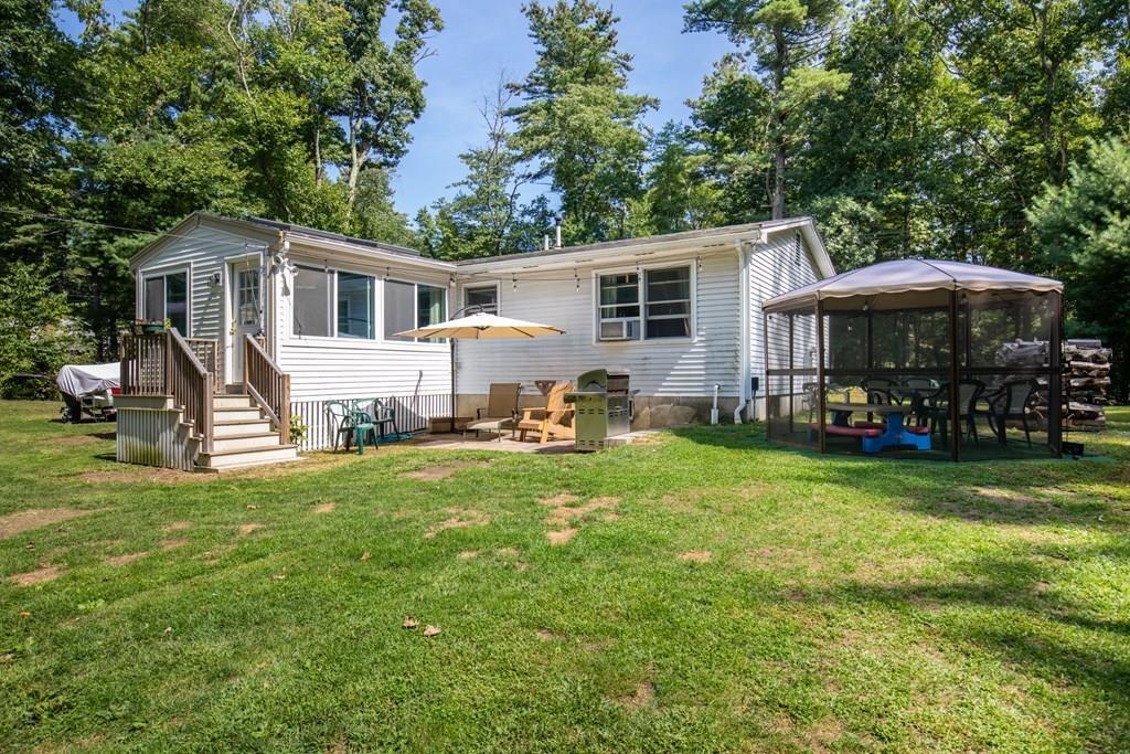 81 Newbury Road Rowley, MA 01969 - Photo 4 of 25 a front view of house with yard and green space