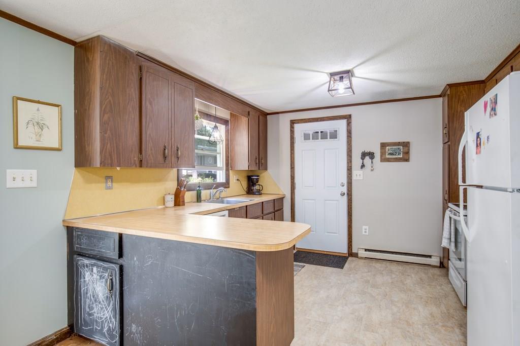 81 Newbury Road Rowley, MA 01969 - Photo 6 of 25 a kitchen with stainless steel appliances granite countertop a refrigerator a sink and a stove