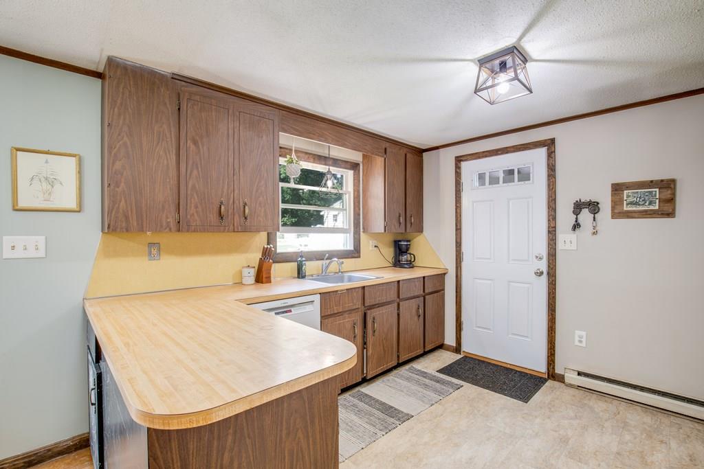 81 Newbury Road Rowley, MA 01969 - Photo 9 of 25 a kitchen with cabinets a sink and appliances