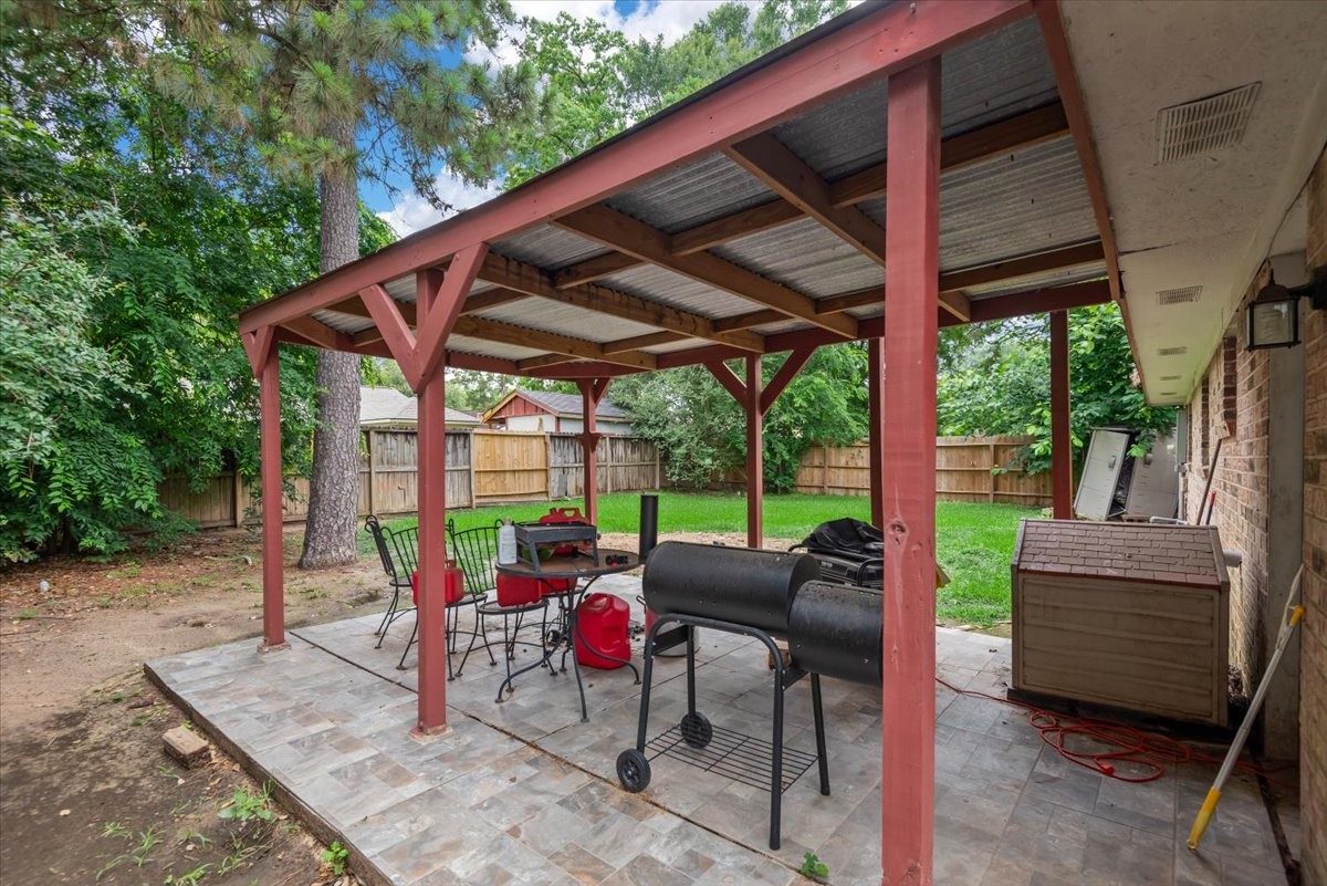 23011 Bayleaf Drive Spring, TX 77373 - Photo 19 of 22 a view of a patio with a table chairs and a backyard