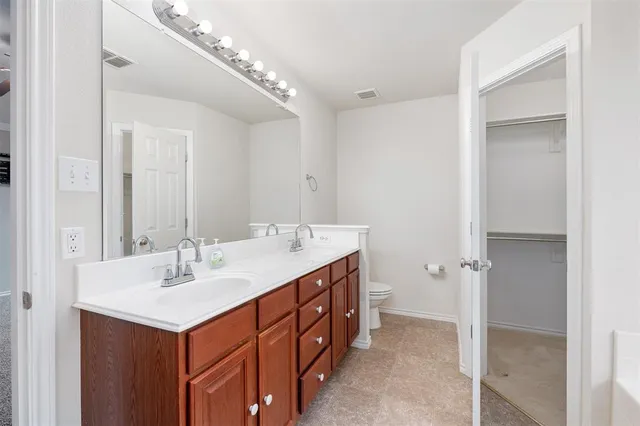 a bathroom with a sink double vanity and a mirror