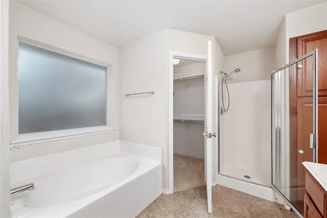 a bathroom with a bathtub and a shower