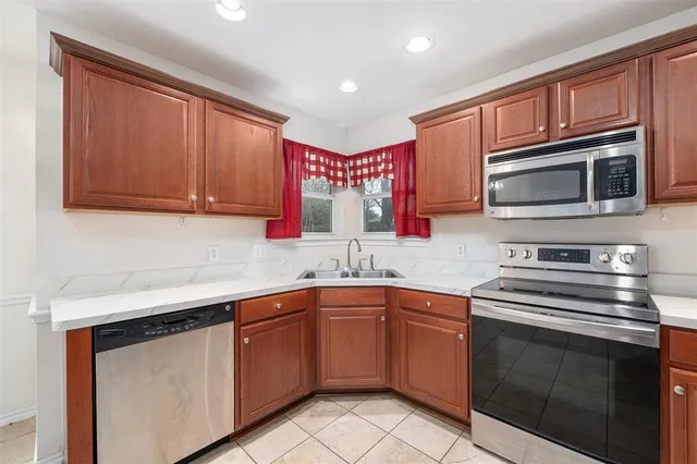 a kitchen with stainless steel appliances granite countertop a sink stove and microwave