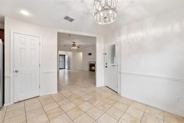 a view of a hallway to rooms and stairs