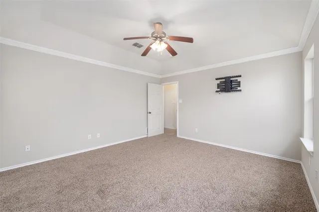 a view of an empty room with a ceiling fan