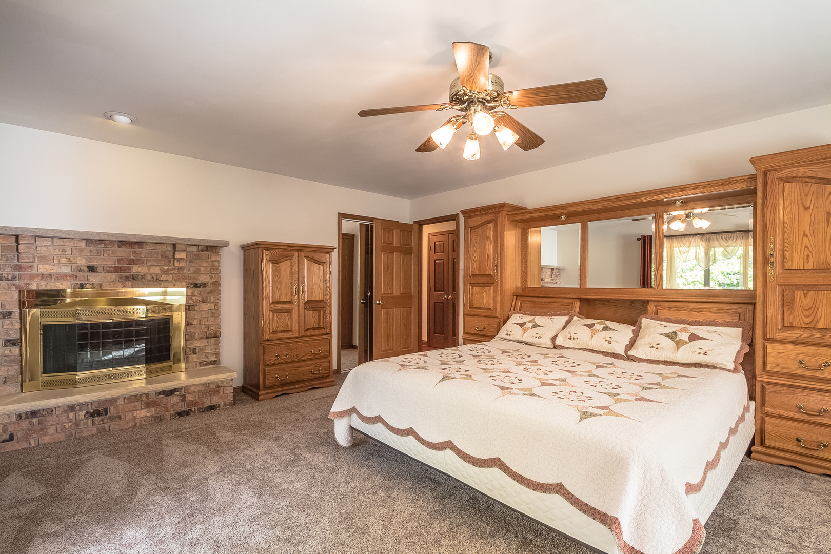 18802 West Manhattan Road Elwood, IL 60421 - Photo 11 of 38 a bed sitting in a room next to a fireplace and window