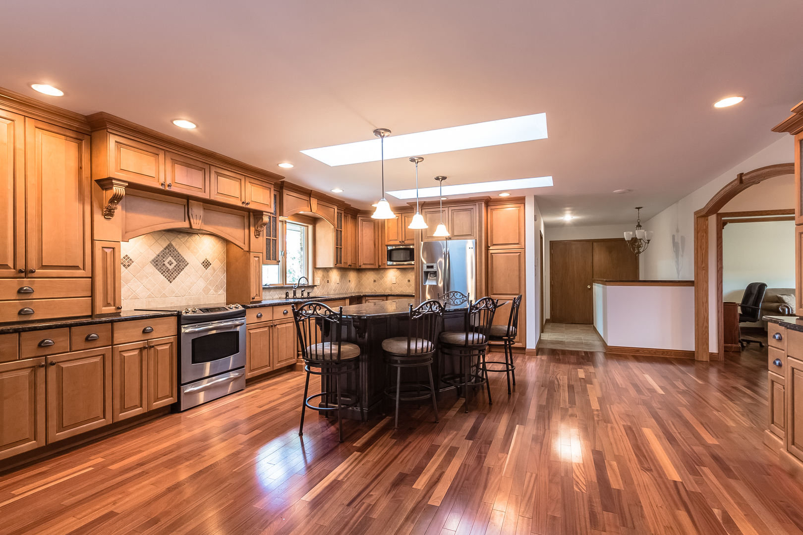 18802 West Manhattan Road Elwood, IL 60421 - Photo 5 of 38 a kitchen with lots of counter top space and painting on the wall