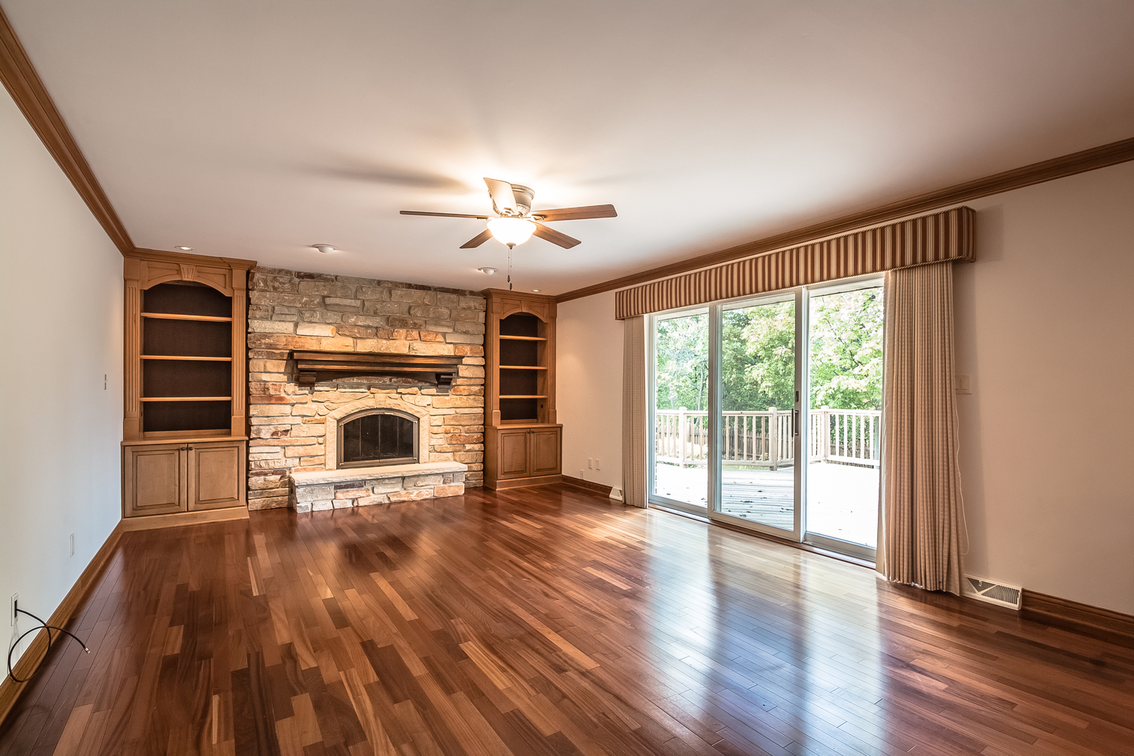 18802 West Manhattan Road Elwood, IL 60421 - Photo 9 of 38 a view of a livingroom with wooden floor a fireplace and window