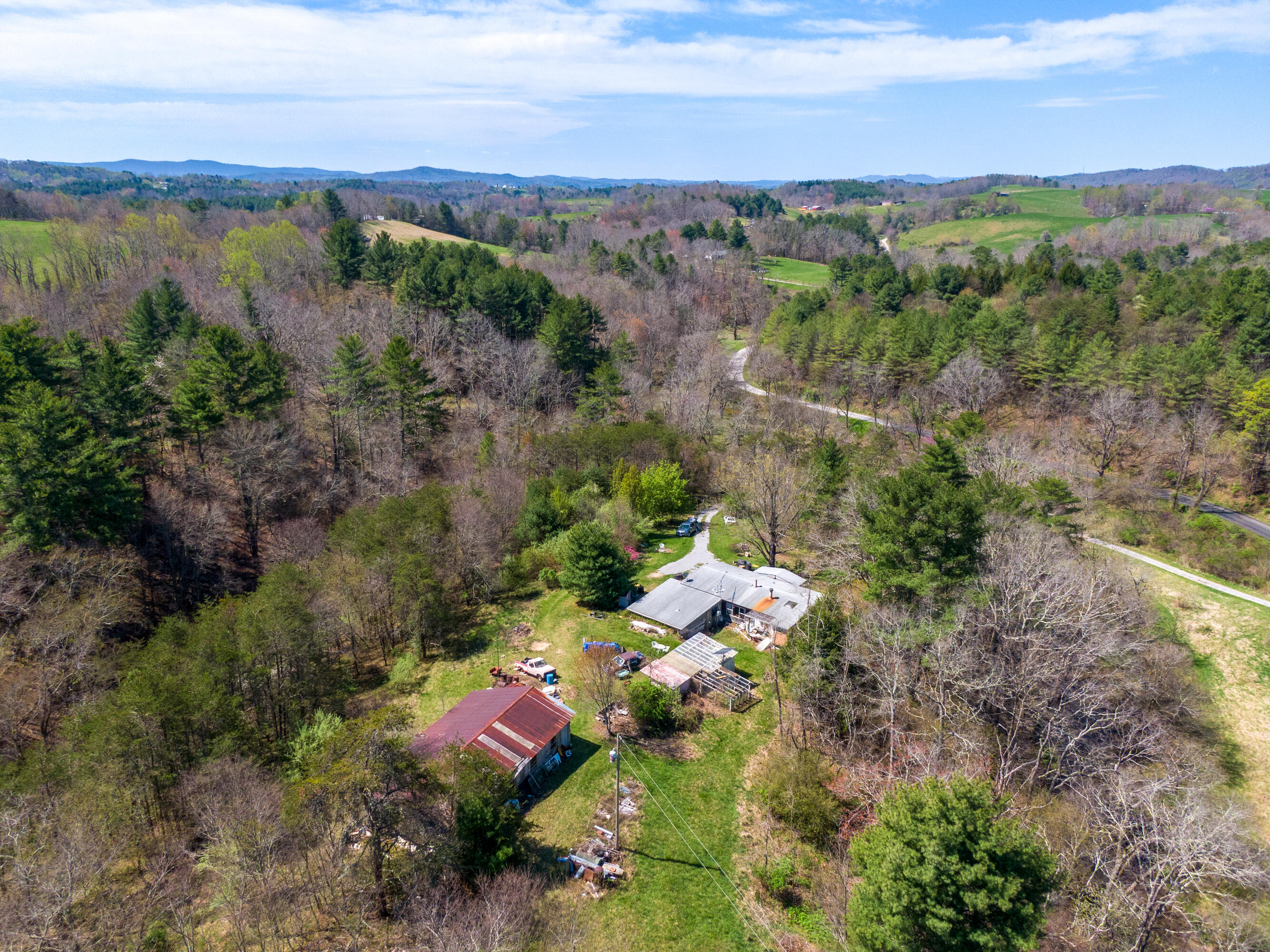 4610 Brush Creek Road Riner, VA 24149 - Photo 4 of 24 an aerial view of green landscape with trees houses and lake view