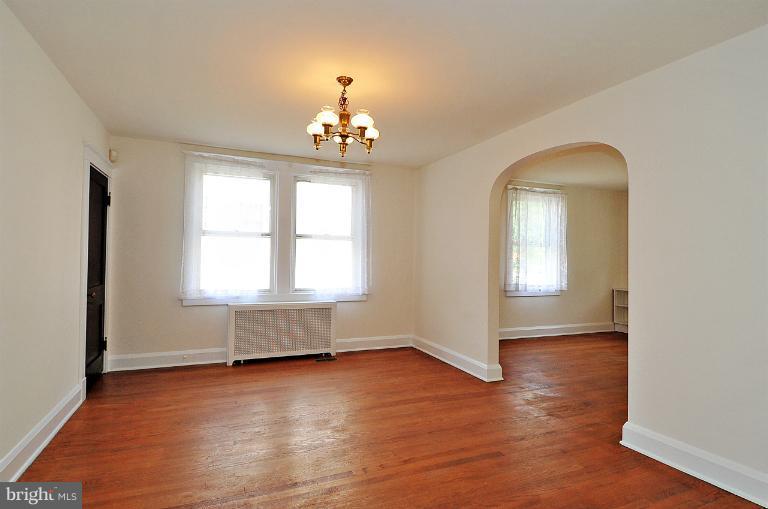 205 Hawthorne Road Linthicum Heights, MD 21090 - Photo 1 of 24 an empty room with wooden floor and windows