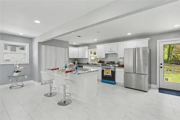 a kitchen with a sink stainless steel appliances and cabinets