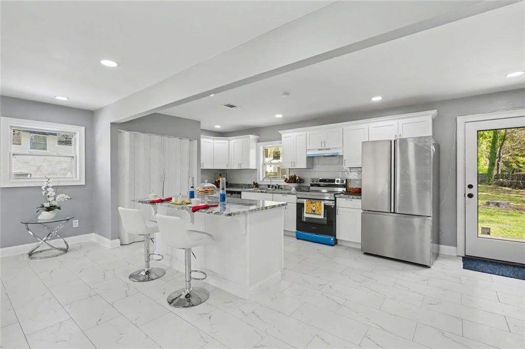 10664 Sandpiper Road Jonesboro, GA 30238 - Photo 14 of 40 a kitchen with a sink stainless steel appliances and cabinets