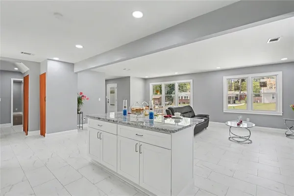a kitchen with refrigerator and cabinets