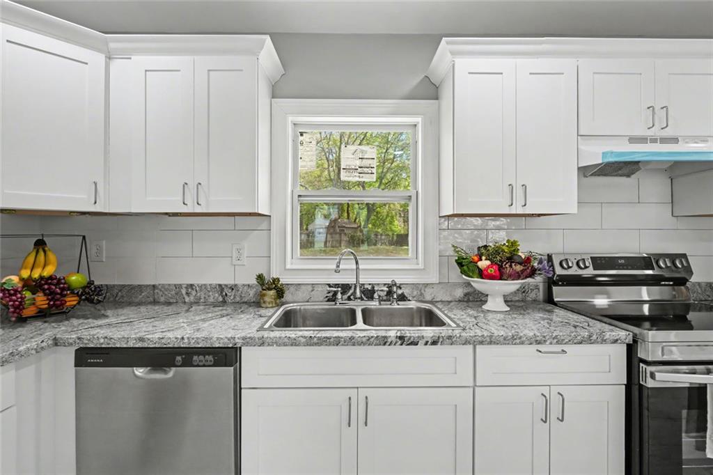 10664 Sandpiper Road Jonesboro, GA 30238 - Photo 18 of 40 a kitchen with sink cabinets and window