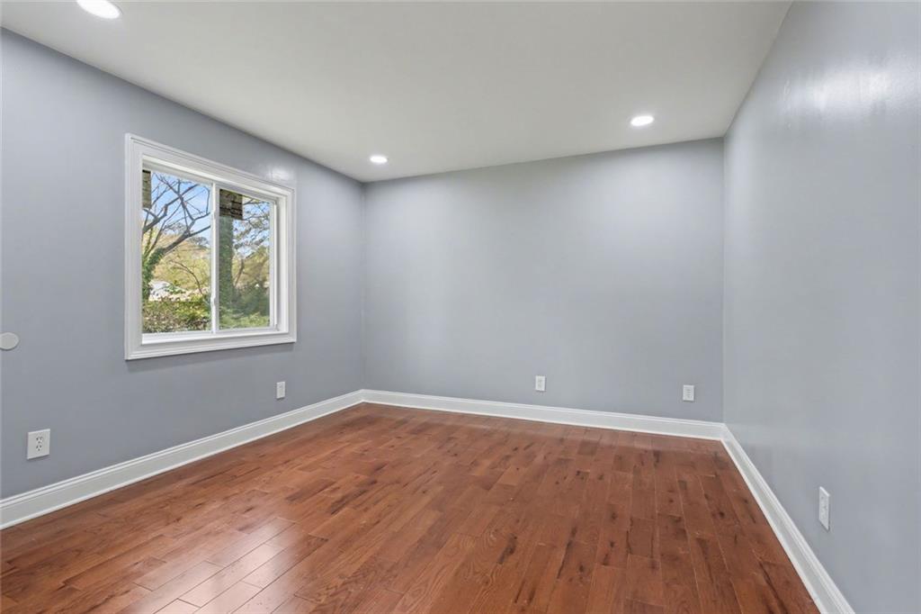 10664 Sandpiper Road Jonesboro, GA 30238 - Photo 21 of 40 wooden floor in an empty room with a window
