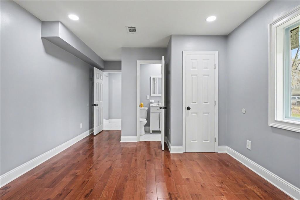 10664 Sandpiper Road Jonesboro, GA 30238 - Photo 22 of 40 wooden floor in an empty room with a window