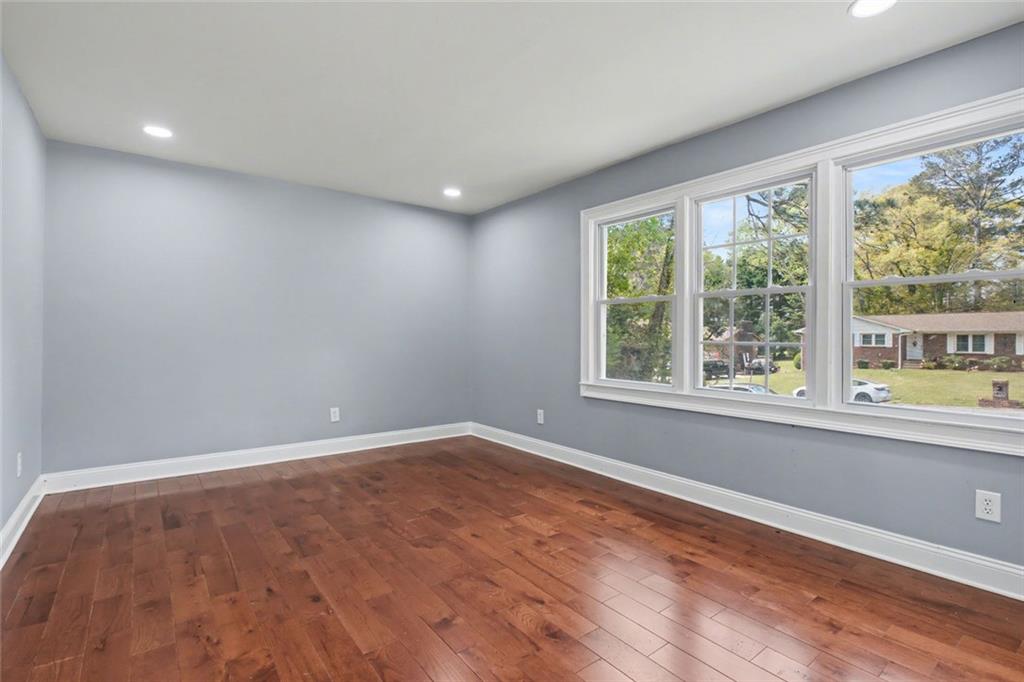 10664 Sandpiper Road Jonesboro, GA 30238 - Photo 24 of 40 wooden floor in an empty room with a window