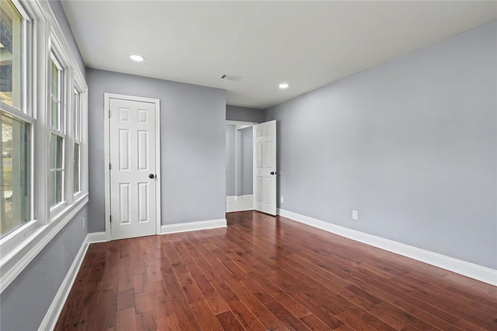 10664 Sandpiper Road Jonesboro, GA 30238 - Photo 25 of 40 a view of an empty room with wooden floor and a window