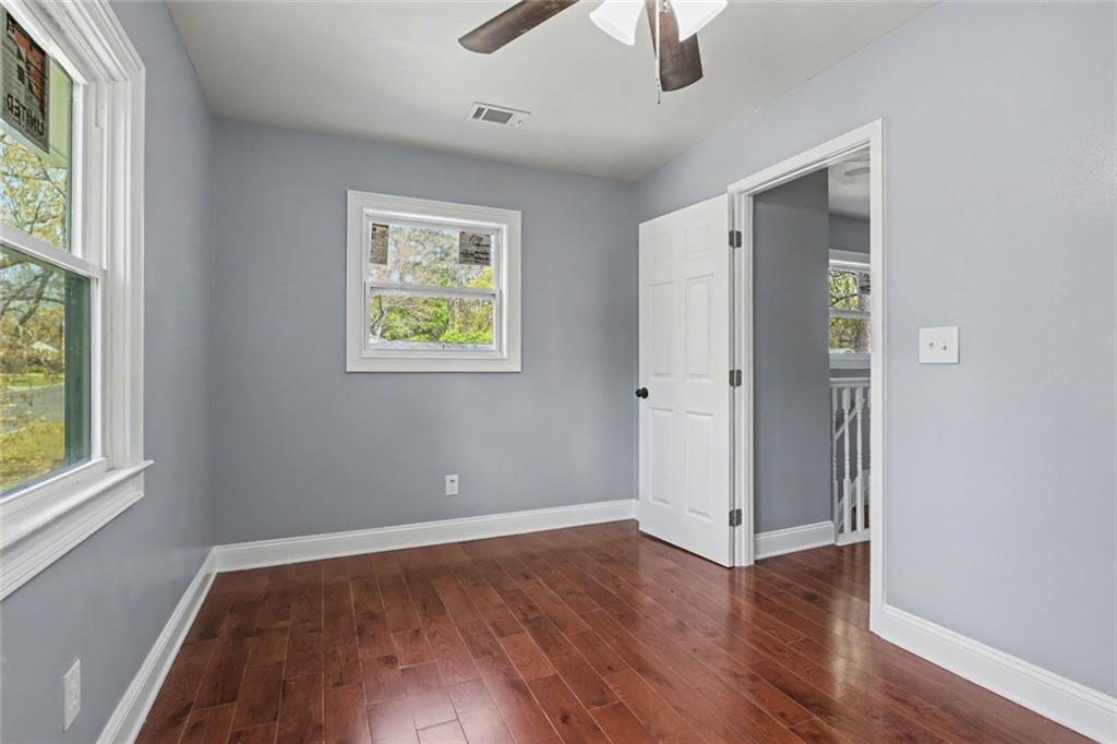 10664 Sandpiper Road Jonesboro, GA 30238 - Photo 27 of 40 an empty room with wooden floor and windows