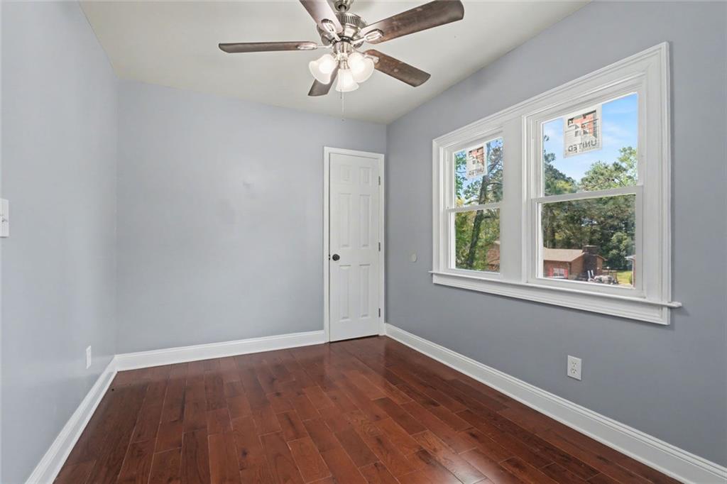 10664 Sandpiper Road Jonesboro, GA 30238 - Photo 28 of 40 a view of wooden floor and windows in a room
