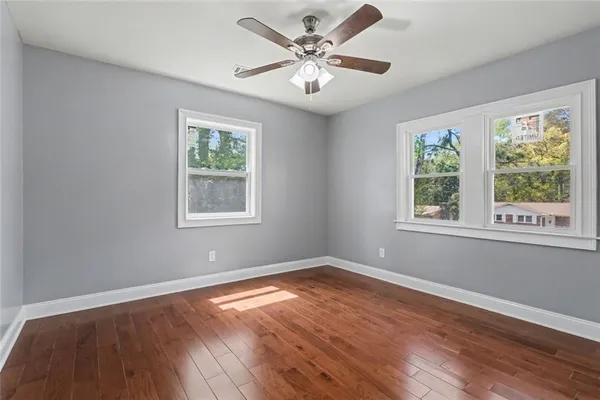 wooden floor in an empty room with a window
