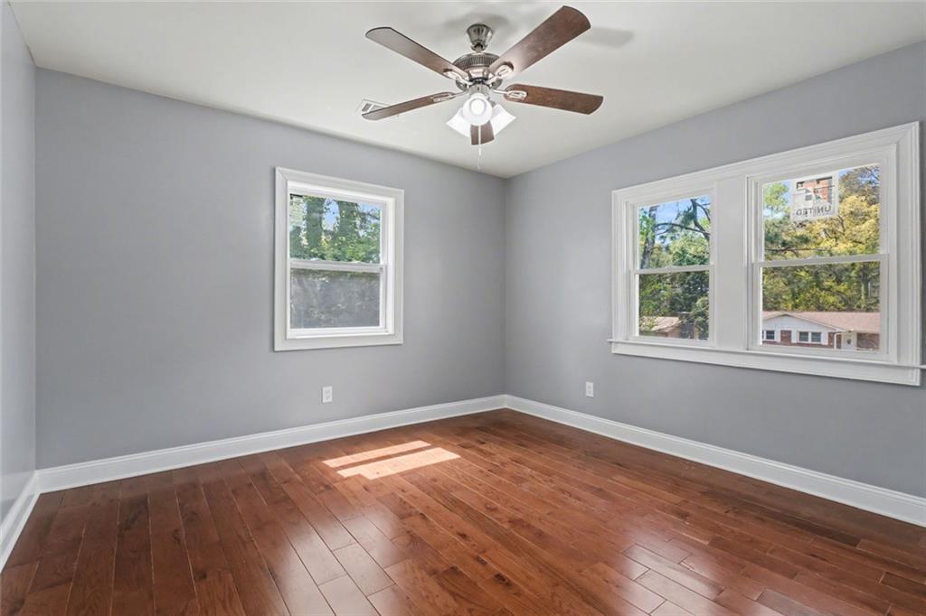 10664 Sandpiper Road Jonesboro, GA 30238 - Photo 29 of 40 a view of an empty room with wooden floor and a window