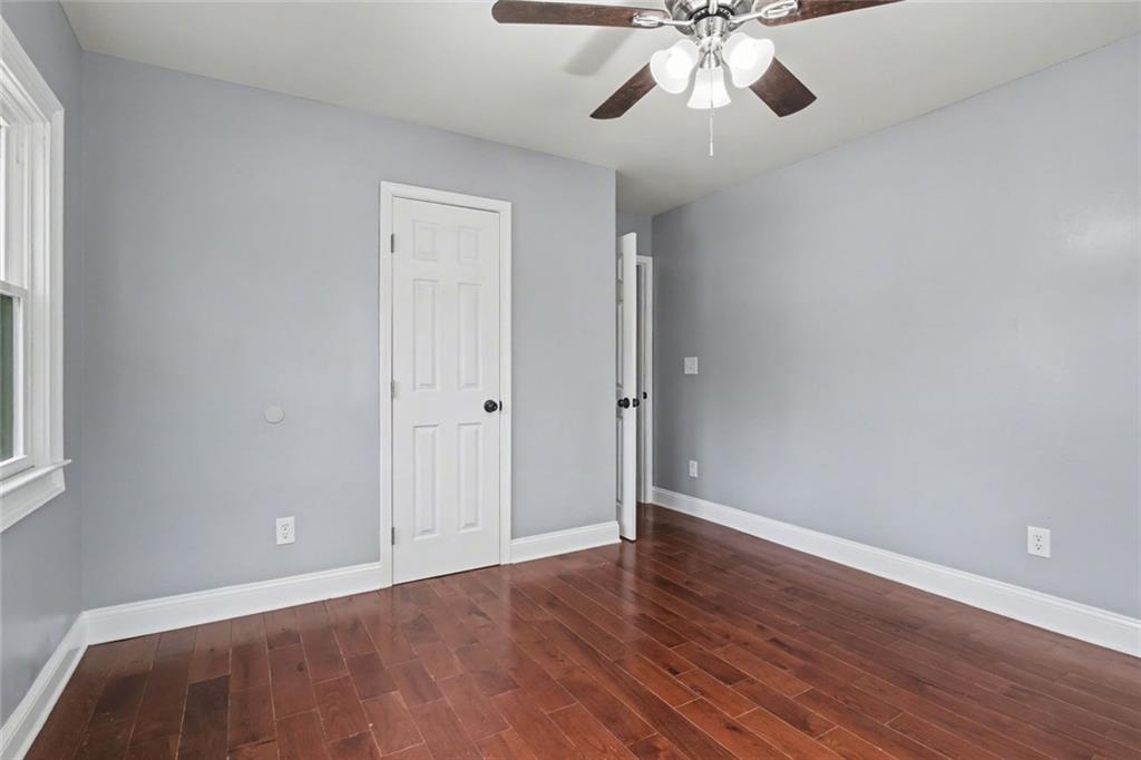 10664 Sandpiper Road Jonesboro, GA 30238 - Photo 30 of 40 wooden floor in an empty room with a window