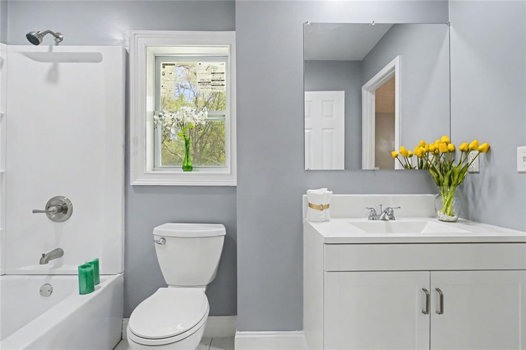 10664 Sandpiper Road Jonesboro, GA 30238 - Photo 34 of 40 a bathroom with a toilet sink and mirror