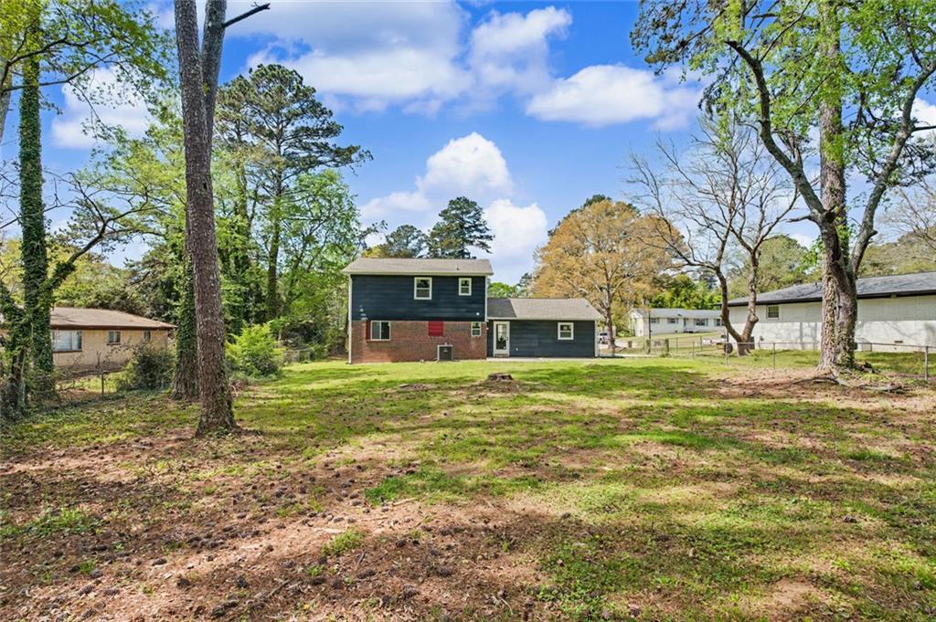 10664 Sandpiper Road Jonesboro, GA 30238 - Photo 36 of 40 a front view of a house with a garden
