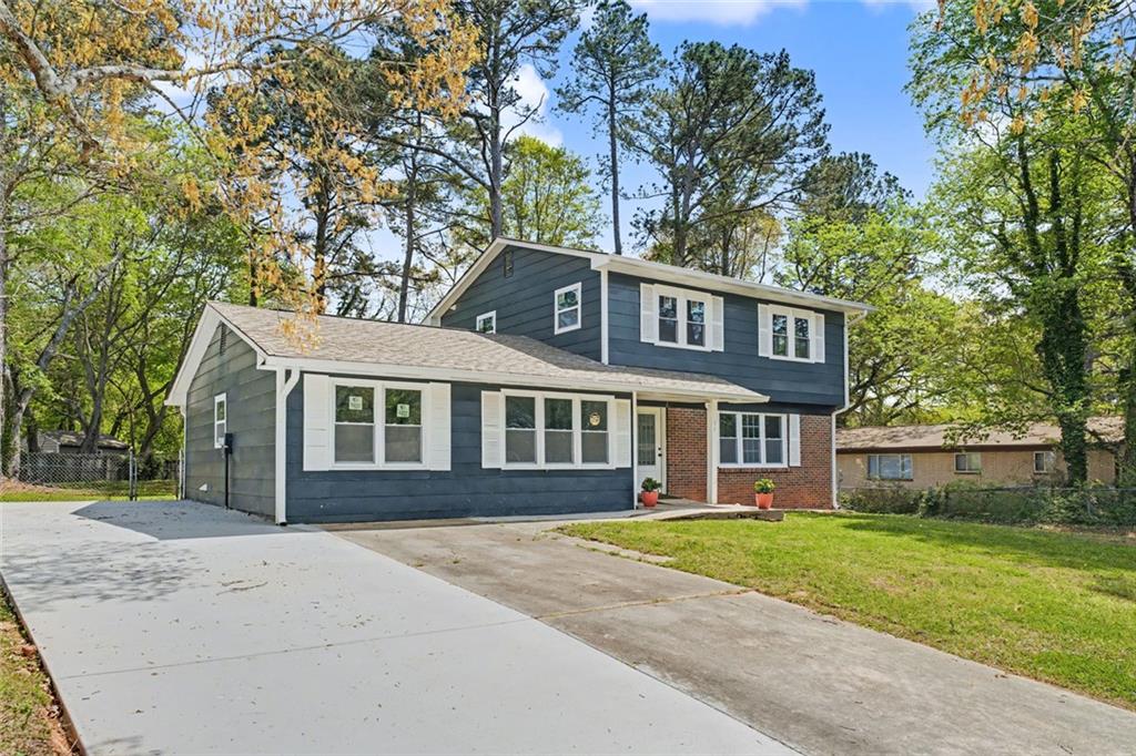 10664 Sandpiper Road Jonesboro, GA 30238 - Photo 4 of 40 a front view of a house with a garden