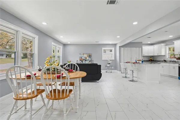 a living room with furniture and kitchen view