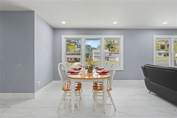 a dining room with furniture and window