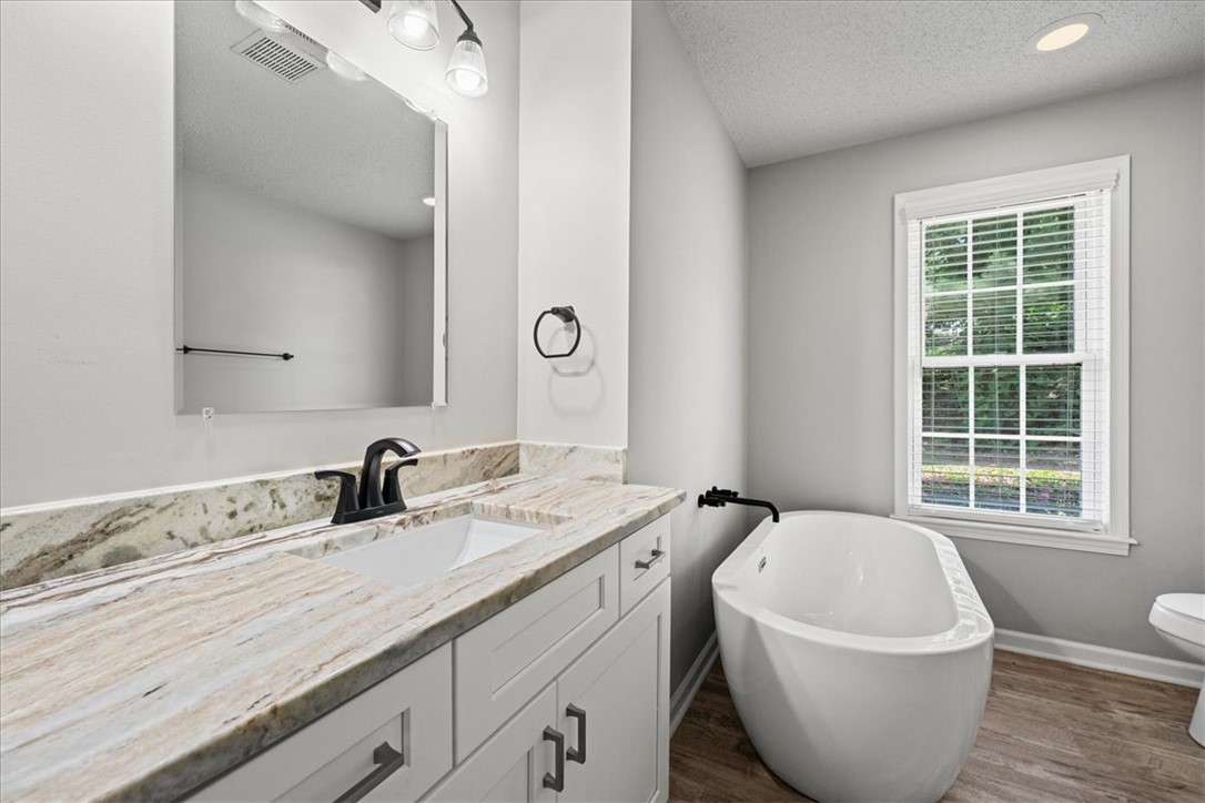 212 Blue Ridge Drive Clemson, SC 29631 - Photo 21 of 33 Elegant freestanding soaking tub and granite counters elevate this primary bathroom.
