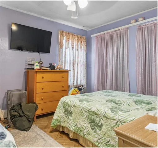 a bedroom with a bed and flat screen tv