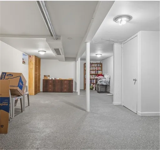 a view of a livingroom with furniture and a gym