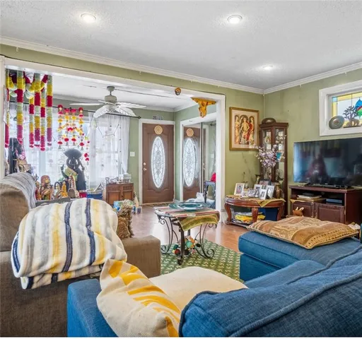 a living room with furniture and a flat screen tv