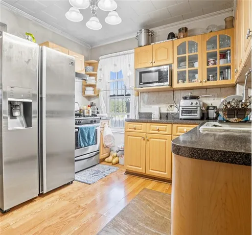 a kitchen with stainless steel appliances granite countertop a refrigerator and a sink