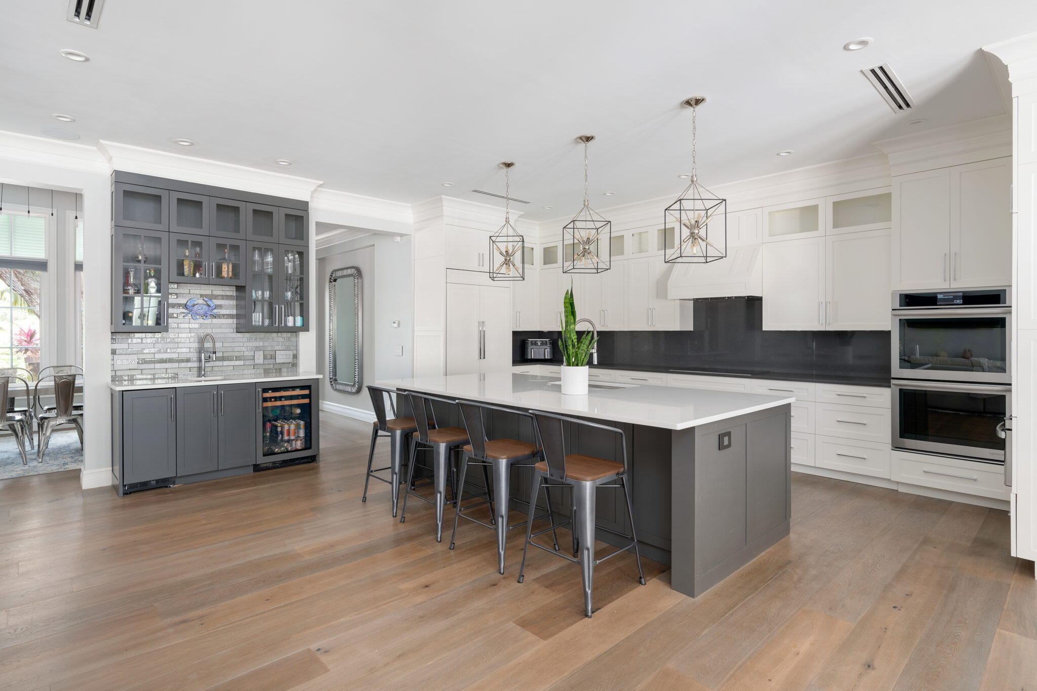 544 Live Oak Road Vero Beach, FL 32963 - Photo 11 of 55 a large kitchen with kitchen island a sink table and chairs