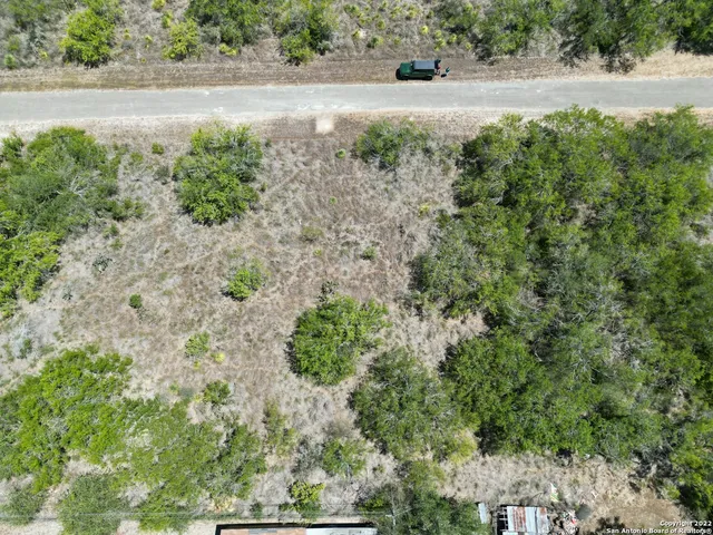an aerial view of house with yard and outdoor space