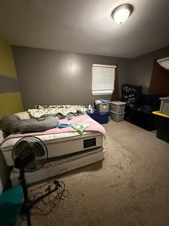 a bedroom with furniture and a window