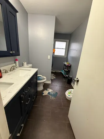 a bathroom with a double vanity sink mirror and shower